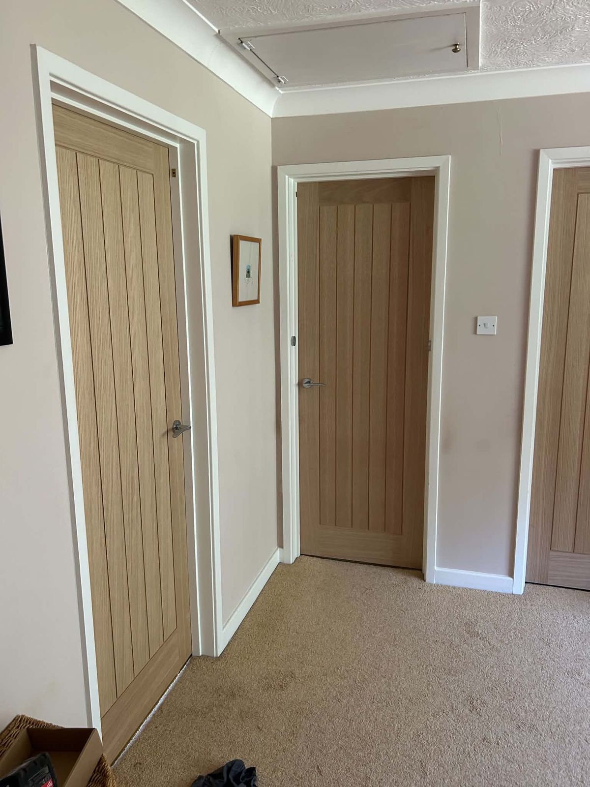 Hallway with three newly fitted oak internal doors and white architrave